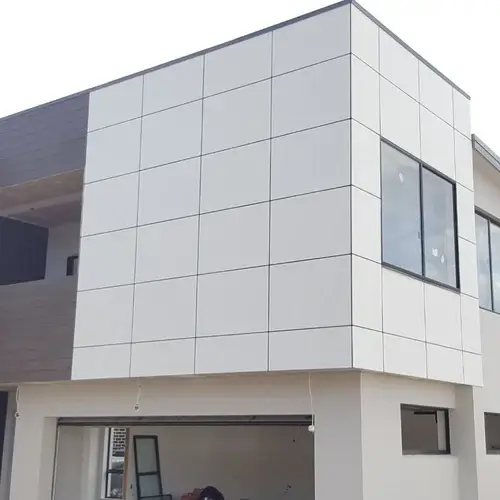 Clean white square panel cladding on a modern home, a sleek finish from Roofing Whangarei’s Cladding Services Whangarei.