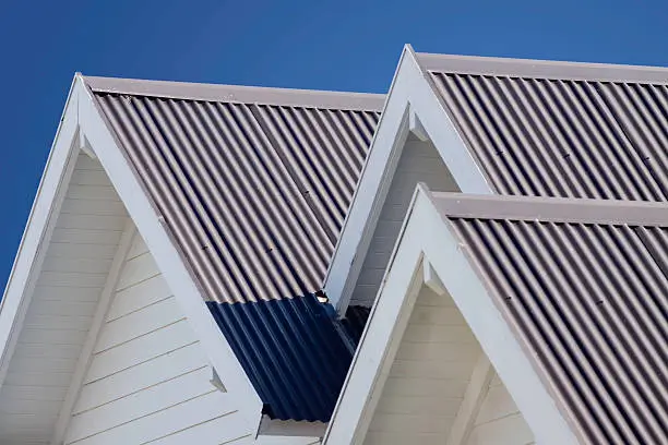 Crisp white gable rooflines with corrugated steel panels, a clean finish delivered by Roofing Whangarei.