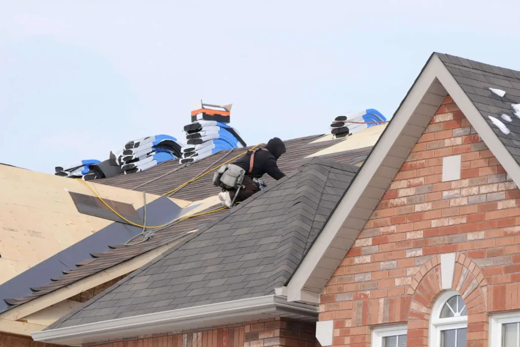 Roofing Whangarei contractor installs shingles during a cold-weather re-roofing upgrade.