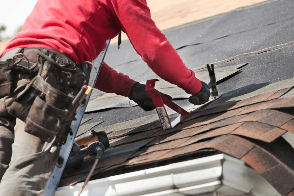 Roofing Whangarei professional repairing minor leaks on a shingle roof as part of routine roof repairs.