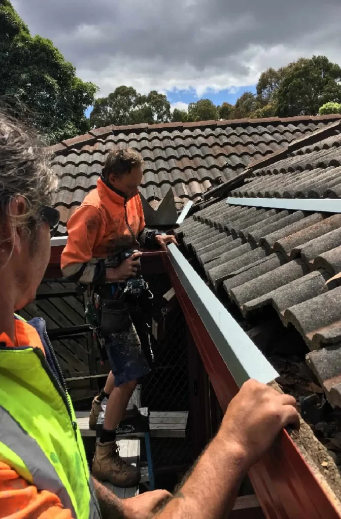 Roofing Whangarei team installing new flashing to improve roof drainage during Gutter and Flashing Repairs.