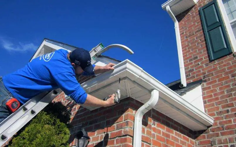 Roofing Whangarei technician aligning guttering to complete high-quality Gutter and Flashing Repairs.