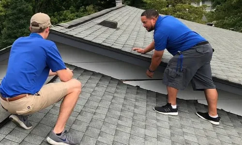 Two Roofing Whangarei team members inspecting a residential roof for potential issues. Two Roofing Whangarei team members inspecting a residential roof for potential issues.